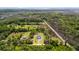 Aerial view of a home with a manicured lawn, and surrounding trees close to marshy waterfront at 795 Shagule Rd, Edisto Island, SC 29438