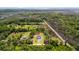 Aerial view of a home with a manicured lawn, and surrounded by trees close to waterfront at 795 Shagule Rd, Edisto Island, SC 29438