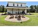 Inviting backyard with a stone fire pit, seating area, and covered patio, perfect for outdoor gatherings at 795 Shagule Rd, Edisto Island, SC 29438