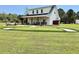 Expansive backyard featuring a putting green, fire pit, and lounge chairs for outdoor enjoyment and recreation at 795 Shagule Rd, Edisto Island, SC 29438