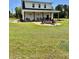 Well-maintained backyard includes an expansive lawn and a fire pit area at 795 Shagule Rd, Edisto Island, SC 29438
