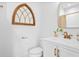 Bright bathroom featuring a vanity, brass fixtures, and decorative mirror at 795 Shagule Rd, Edisto Island, SC 29438