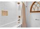 Classic bathroom with white subway tiles, brass fixtures, and decorative window at 795 Shagule Rd, Edisto Island, SC 29438