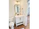Bathroom features a white vanity and a decorative mirror with gold accents at 795 Shagule Rd, Edisto Island, SC 29438