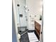 Bathroom features a glass shower, black hexagonal tiles, and a wood vanity at 795 Shagule Rd, Edisto Island, SC 29438