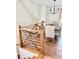 Stylish dining area with hardwood floors and a view from the staircase, featuring an elegant light fixture and seating at 795 Shagule Rd, Edisto Island, SC 29438