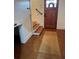Entryway with shiplap walls, stairs, a rustic wooden door, and a decorative rug, creating a warm welcome at 795 Shagule Rd, Edisto Island, SC 29438