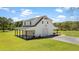 A modern two-story white home with a garage, covered porch, and neatly landscaped lawn offering comfort and style at 795 Shagule Rd, Edisto Island, SC 29438