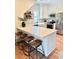 Well-lit kitchen with white cabinetry, stainless steel appliances, and barstool seating at the island's countertop at 795 Shagule Rd, Edisto Island, SC 29438