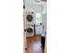 Compact laundry room featuring a stacked washer and dryer, storage cabinets, and natural light, ideal for convenience at 795 Shagule Rd, Edisto Island, SC 29438