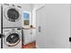 Convenient laundry room with stacked washer and dryer, storage cabinets, and wood countertop at 795 Shagule Rd, Edisto Island, SC 29438