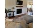 Cozy living room with a fireplace and wooden mantle, complemented by modern decor and comfortable seating at 795 Shagule Rd, Edisto Island, SC 29438