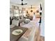 Open-concept living room and kitchen with hardwood floors and neutral tones, creating a bright and welcoming space at 795 Shagule Rd, Edisto Island, SC 29438