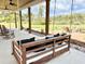 Relaxing porch with a swing bed, rocking chairs, and views of the expansive yard and outdoor fire pit at 795 Shagule Rd, Edisto Island, SC 29438