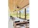 Long, covered porch with ceiling fans, a porch swing, rocking chairs, and ample space for outdoor relaxation at 795 Shagule Rd, Edisto Island, SC 29438