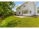 Spacious backyard featuring a well-maintained lawn, patio, privacy fence, and view of the home's exterior at 828 Williamsburg Ln, Charleston, SC 29414
