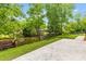 Backyard showing a stamped concrete patio and access to a pond with a wood dock and waterfront views at 828 Williamsburg Ln, Charleston, SC 29414