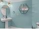 Stylist powder room with modern fixtures, pedestal sink and decorative mirror at 828 Williamsburg Ln, Charleston, SC 29414