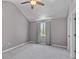This bedroom features vaulted ceilings, fan, and a window with curtains at 828 Williamsburg Ln, Charleston, SC 29414