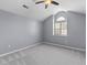 Cozy bedroom with gray walls, plush carpeting, fan and a large window at 828 Williamsburg Ln, Charleston, SC 29414