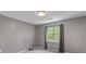 Minimalist bedroom with neutral walls, carpet floors, and a window with green views at 828 Williamsburg Ln, Charleston, SC 29414