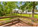 Scenic view from a wooden deck overlooking lush greenery and a tranquil pond, perfect for relaxation at 828 Williamsburg Ln, Charleston, SC 29414