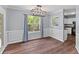 Charming dining area featuring hardwood floors, a modern light fixture, and elegant wall paneling at 828 Williamsburg Ln, Charleston, SC 29414