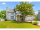 Well maintained home with manicured lawn, a one-car garage and a bright yellow front door at 828 Williamsburg Ln, Charleston, SC 29414