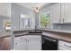 Cozy view of the kitchen sink area, featuring white cabinets and plenty of natural light at 828 Williamsburg Ln, Charleston, SC 29414