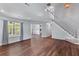 Open-concept living space with hardwood floors, high ceilings, and a staircase to the second floor at 828 Williamsburg Ln, Charleston, SC 29414