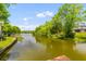 Scenic view of a waterway surrounded by mature trees, offering a serene and natural setting at 828 Williamsburg Ln, Charleston, SC 29414