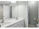 Bathroom featuring double sinks and a large mirror at 8676 Grassy Oak Trl, North Charleston, SC 29420