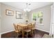 Bright dining room with wood table, chandelier, and ample natural light, perfect for Gathering gatherings at 8676 Grassy Oak Trl, North Charleston, SC 29420