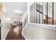 Inviting entryway featuring wood floors, a staircase with wrought iron railings, and a view into the living room at 8676 Grassy Oak Trl, North Charleston, SC 29420