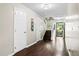Long hallway with hardwood floors, multiple doors, and a staircase leading to the upper level at 8676 Grassy Oak Trl, North Charleston, SC 29420