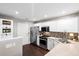 Well-lit kitchen features stainless steel appliances, sleek countertops, and stylish backsplash at 8676 Grassy Oak Trl, North Charleston, SC 29420