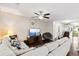 Cozy living room with plush sectional, ceiling fan, and stylish decor, creating a relaxing atmosphere at 8676 Grassy Oak Trl, North Charleston, SC 29420