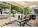 Relaxing screened patio with cushioned seating and a view of the backyard at 8676 Grassy Oak Trl, North Charleston, SC 29420
