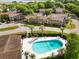 Aerial view of the condominium complex with a pool surrounded by lush landscaping and palm trees at 870 Colony Dr # 14, Charleston, SC 29407