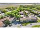 An aerial view showing the residential buildings surrounded by mature trees and manicured lawns and a marsh view at 870 Colony Dr # 14, Charleston, SC 29407