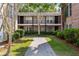 A quaint brick building with lush landscaping and a concrete walkway at 870 Colony Dr # 14, Charleston, SC 29407