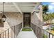 Brick home's second floor entry with railing and exterior lighting at 870 Colony Dr # 14, Charleston, SC 29407
