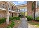 Brick building courtyard with walkway, stairs and ornate ironwork at 870 Colony Dr # 14, Charleston, SC 29407