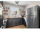 A well-lit kitchen featuring dark cabinets, wood counters, stainless steel appliances, and open shelving at 870 Colony Dr # 14, Charleston, SC 29407