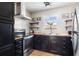 Modern kitchen featuring black cabinetry, butcher block countertops, subway tile backsplash, and stainless steel appliances at 870 Colony Dr # 14, Charleston, SC 29407
