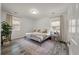 Bright bedroom with a metal frame bed, neutral decor, large windows, and hardwood floors at 928 Sycamore Ave, Charleston, SC 29407