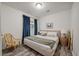 Charming bedroom with a pink upholstered bed, dark blue curtains, and a woven accent chair at 928 Sycamore Ave, Charleston, SC 29407