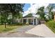A charming home with a quaint front porch, stone driveway, and lush green surroundings at 928 Sycamore Ave, Charleston, SC 29407