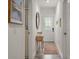 Bright hallway with white walls, decor, wood-look floors and an eye-catching front door at 928 Sycamore Ave, Charleston, SC 29407