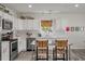 Bright kitchen boasting white cabinetry, stainless appliances, and charming natural light at 928 Sycamore Ave, Charleston, SC 29407